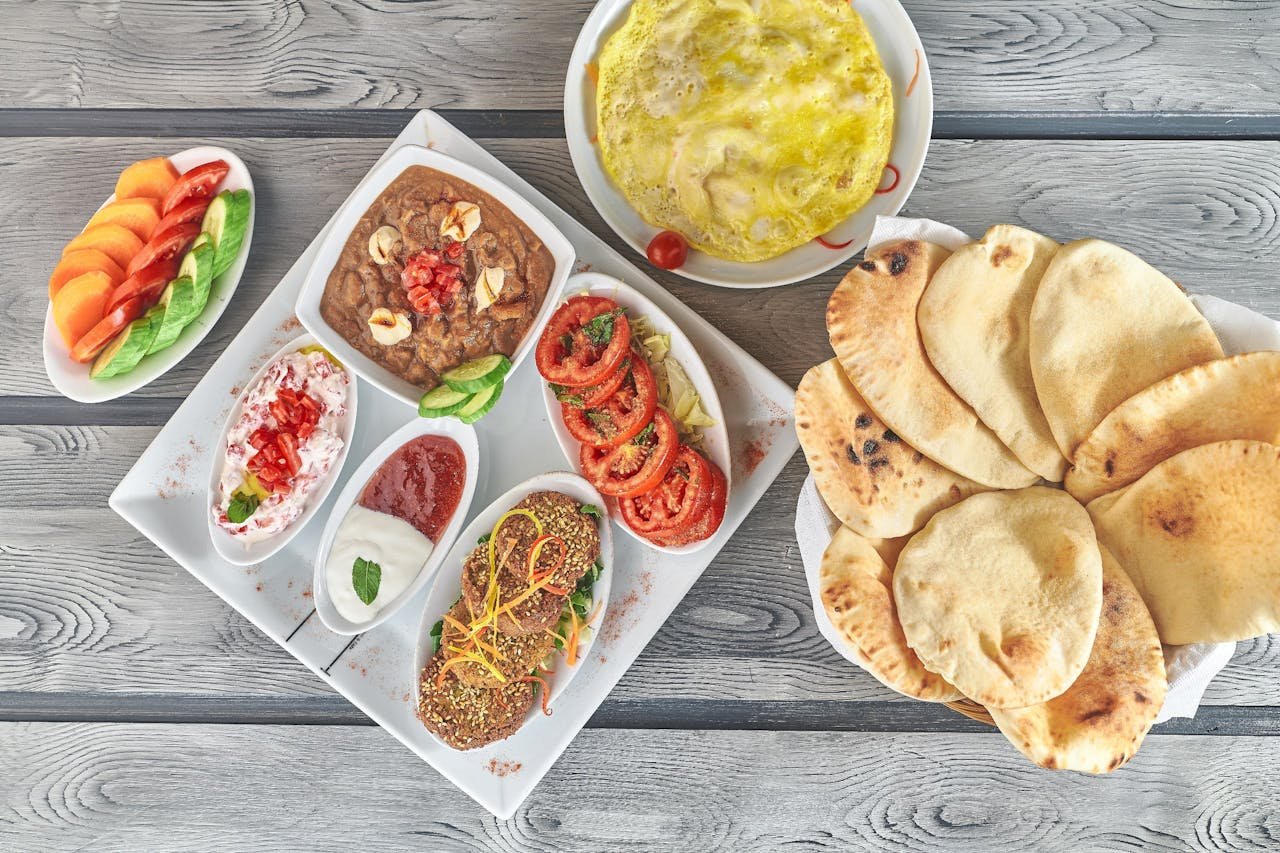 A vibrant spread of Middle Eastern dishes featuring hummus, falafel, and fresh vegetables.